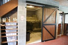 an open barn door with hay in it