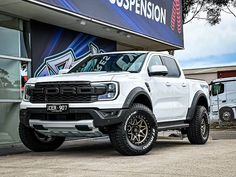 a white truck parked in front of a building