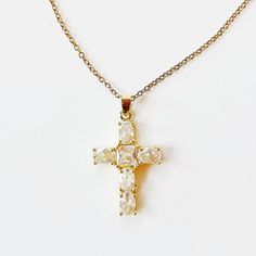 Introducing our Cross My Heart Necklace—a beautifully dainty piece that adds a touch of elegance to any outfit. Crafted in stunning gold, this timeless necklace features a delicate cross design adorned with a hint of sparkle, making it perfect for both everyday wear and special occasions. Lightweight and versatile, the Cross My Heart Necklace is designed for those who appreciate subtle sophistication. Whether you’re layering it with other pieces or wearing it solo, this necklace radiates a warm glow that complements your unique style. Celebrate your faith and express your individuality with this charming accessory. The Cross My Heart Necklace is not just a piece of jewelry; it’s a heartfelt statement that you’ll cherish for years to come. Perfect for gifting or as a special treat for yours Yellow Gold Cross Pendant Necklace For Weddings, Elegant Gold Plated Cross Pendant Necklace, Wedding Yellow Gold Cross Pendant Necklace, Gold Pendant Cross Necklace For Wedding, Gold Crucifix Necklace For Wedding, Elegant Gold Cross Necklace For Wedding, Delicate Cross Necklaces For Weddings, Dainty Gold Cross Necklace For Anniversary, Delicate Cross Necklace For Wedding