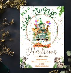 an animal themed birthday party with animals on the front and back of it, surrounded by greenery