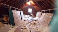 the attic is filled with insulation and wood flooring