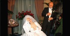 a bride and groom standing next to each other in front of a table full of people