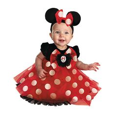 a baby girl wearing a minnie mouse costume