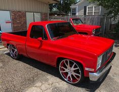 two red trucks parked next to each other