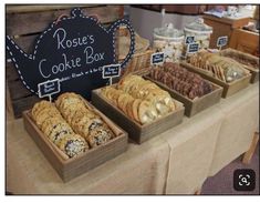 there are many different types of cookies in the box on display at this market stall