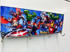 the avengers wall hangings are made from metal hooks and have cartoon characters painted on them