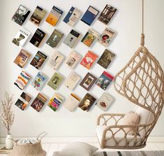 a room with a hanging chair and many books on the wall