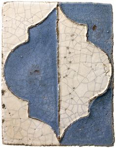 an old tile with blue and white designs on the bottom half, in different shades