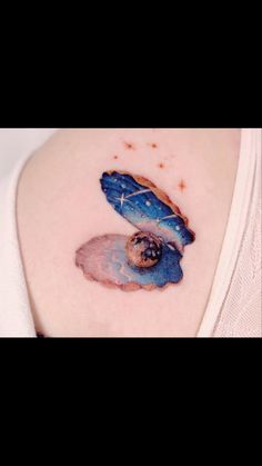 a woman's shoulder with a tattoo on it that has a blue bird flying through the sky