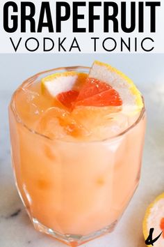 the grapefruit vodka tonic is garnished with an orange slice