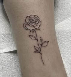 a single rose tattoo on the ankle