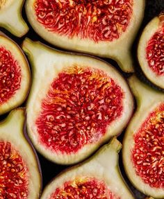 some cut up pieces of fruit sitting on top of each other with red seeds in them