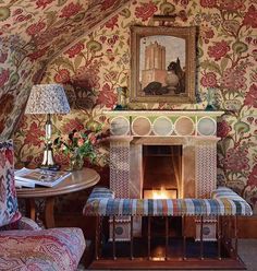 a living room filled with furniture and a fire place next to a painting on the wall