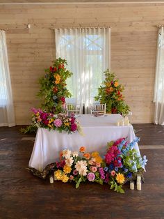 the table is covered with flowers and candles