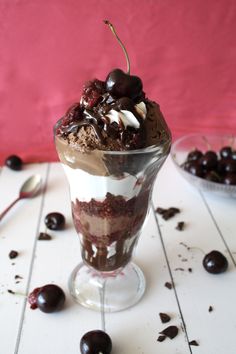 an ice cream sundae with chocolate and cherries