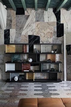 a living room filled with furniture and walls covered in marble