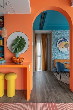 an orange and blue living room with yellow stools