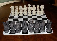 a chess board with some statues on it