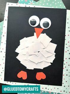 a penguin made out of white paper and some scissors on top of it with the words gludtmycrafts