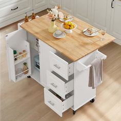 a small kitchen island with drawers on wheels