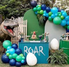 a dinosaur birthday party with balloons and decorations