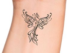 a tattoo design on the side of a woman's arm with an intricate bird