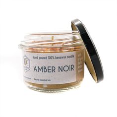 an amber noir candle in a glass jar