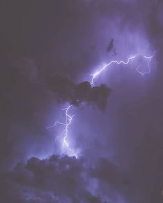 the sky is filled with purple lightning and some dark clouds are visible in the background