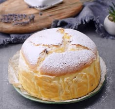 a cake sitting on top of a plate covered in powdered sugar