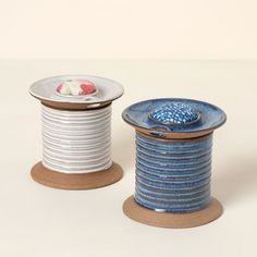 two spools of thread sitting next to each other