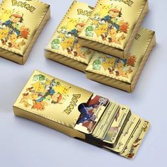 four pokemon themed business cards are shown in this image, one is gold and the other is yellow