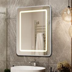 a white sink sitting under a bathroom mirror next to a wall mounted faucet