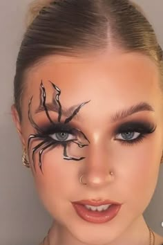 Description: Turn heads this Halloween with a bold and eerie spiderweb-inspired makeup look. Featuring a dramatic smoky eye, glossy dark lips, and an intricately detailed web drawn over your eyes, this look is both spooky and glam. The soft blending of black and deep red shades adds a touch of mystery, while the spiderweb design creeping across your face gives an extra fright factor. Pair it with a sleek costume for an unforgettable Halloween transformation! Ideal for those who want to make a stunning, creative statement. Spiderweb Makeup, Puppet Makeup, Glitter Halloween Makeup, Halloween Transformation, Gothic Eye Makeup, Unique Halloween Makeup, Spiderweb Design