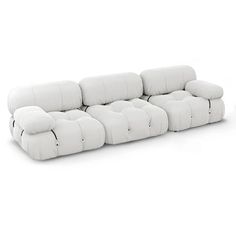 a white couch sitting on top of a white floor