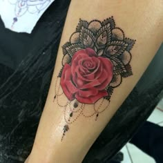 a woman's leg with a rose tattoo on it