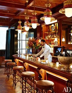 a man is behind the bar at a restaurant