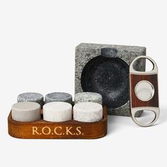 a rock with four different types of rocks in front of it and a wooden box that says rocks