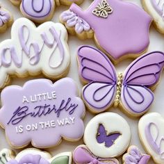 some cookies are decorated with purple and white icing