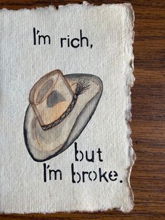 a piece of cloth with an image of a cowboy's hat that says, i'm rich, but i'm broke