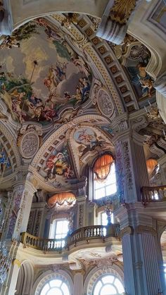 an ornate building with many windows and paintings on the ceiling