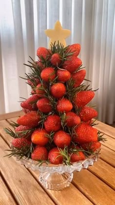 a christmas tree made out of strawberries on a table