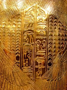 an egyptian gold plate with some writing on it