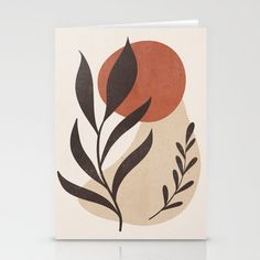 an art print with leaves and a red sun in the background on a white wall