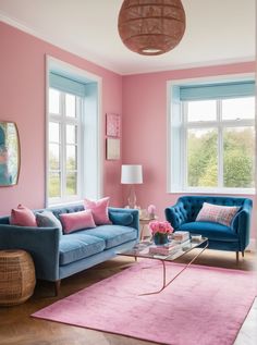 a living room with pink walls and blue couches