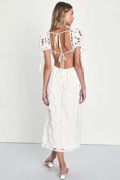 You'll bring all the sweetness to your summer soirees in the Lulus Flourishing Blossoms White 3D Floral Backless Midi Dress! Gorgeous lace-inspired fabric has a pattern of cutouts and floral embroidery as it shapes this dreamy dress. Sheer puff sleeves boast drawstring ties at the cuffs and frame a bodice with a deep V-neckline and a flirty open back, crossed by a single tie. Banded waist tops an A-line skirt that falls to a midi hem. Three-dimensional applique flowers throughout add a lush fini Spring Lace Backless Dress, Spring Backless Lace Dresses, Backless Lace Dresses For Spring, Backless Lace Dress For Garden Party, Summer Midi Dress With Tie Back For Party, Summer Lace Midi Dress With Short Sleeves, White Dress For A Garden Party, Backless Summer Midi Dress For Party, Summer Backless Midi Dress For Party