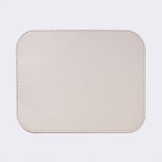 a white leather tray with stitching on the sides and an empty square in the middle