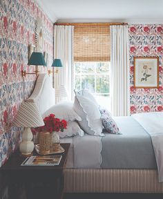 an open book shows a bedroom with floral wallpaper and bedding, along with two lamps on either side of the bed