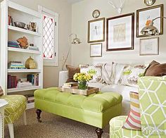 a living room filled with lots of furniture and pictures on the wall above it's bookshelf