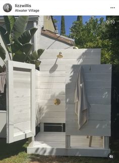 the outside of a house with a shower and towel rack