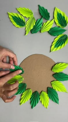 someone is making some paper leaves out of cardboard